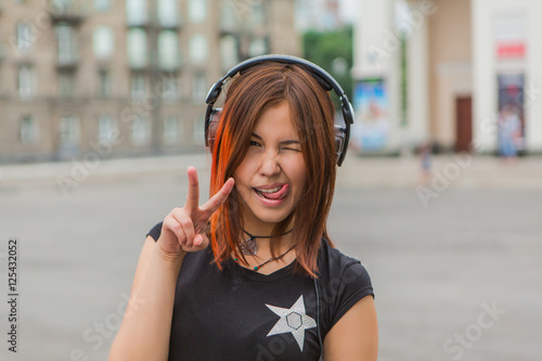 Asian girl listening to music with headphones photo