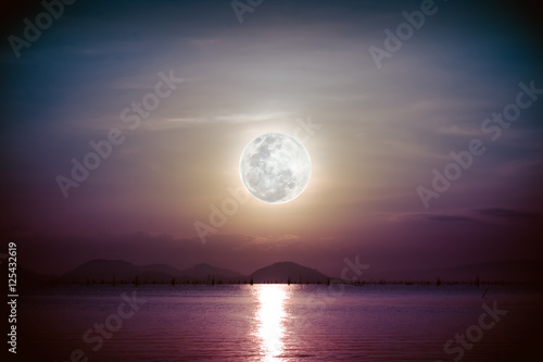Romantic scenic with full moon on sea to night. Reflection of moon.