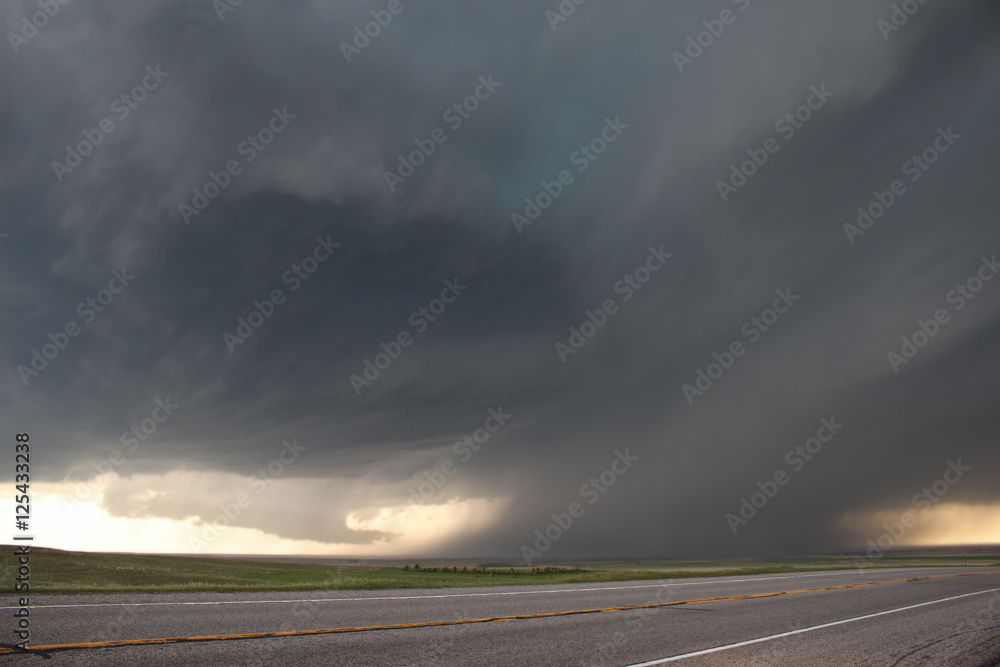An intense supercell thunderstorm glides over the high plains of eastern Colorado in the springtime.