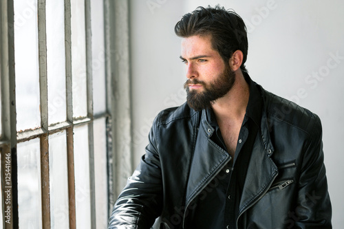 Fotografie Lifestyle rugged rough masculine bearded man in leather jacket gritty edgy sexy