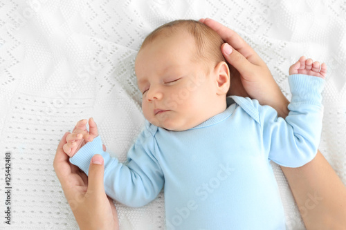 Mother hands touching cute ...