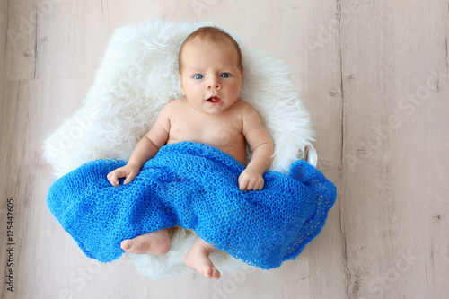 Cute baby lying on white fl...