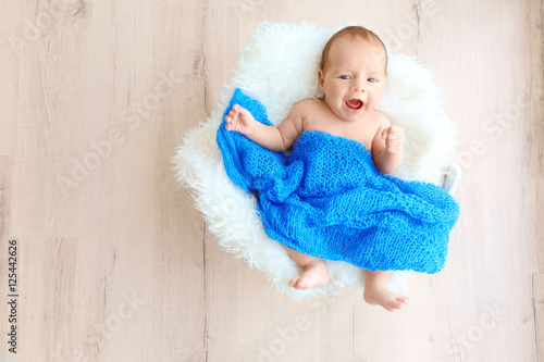 Cute baby lying on white fl...