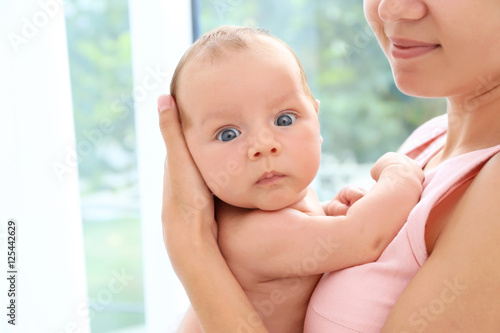 Woman with cute baby on lig...