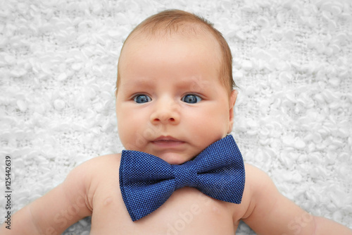 Cute baby with bow tie lyin...