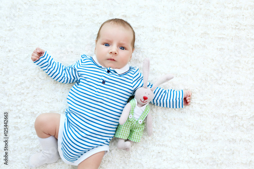 Cute baby with cuddly rabbi...