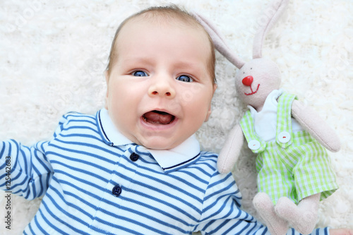 Cute baby with cuddly rabbi...