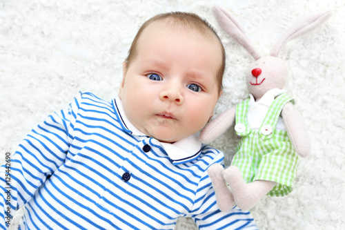 Cute baby with cuddly rabbi...