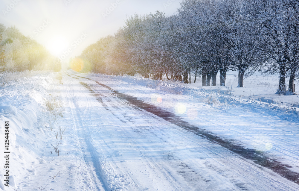 Obraz premium Winter snow-covered, slippery country road