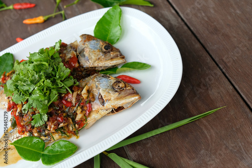 fried mackerel fish and chilli sauce on white plate