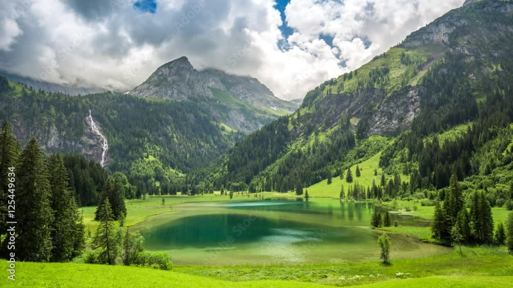Dramatic 4K Timelapse of Lauenensee ( lake Lauenen) with waterfall and Swiss Alps in the background near Gstaad, canton Bern, Switzerland