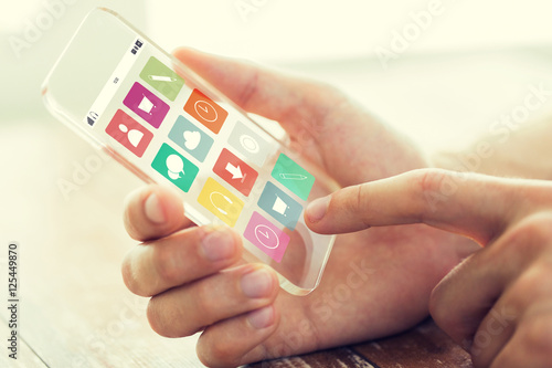 Wallpaper Mural close up of hand with menu icons on smartphone Torontodigital.ca