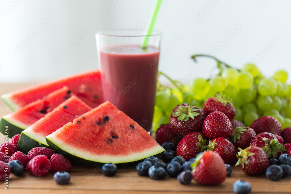 fruit and berry juice or smoothie on wooden table fruit and berry juice or smoothie on wooden table