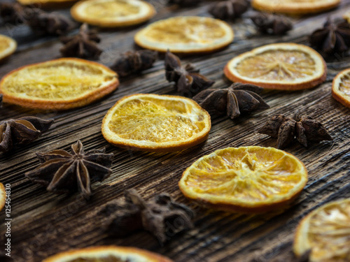 Dried Orange Slices and Star Aniseed on Wooden Board