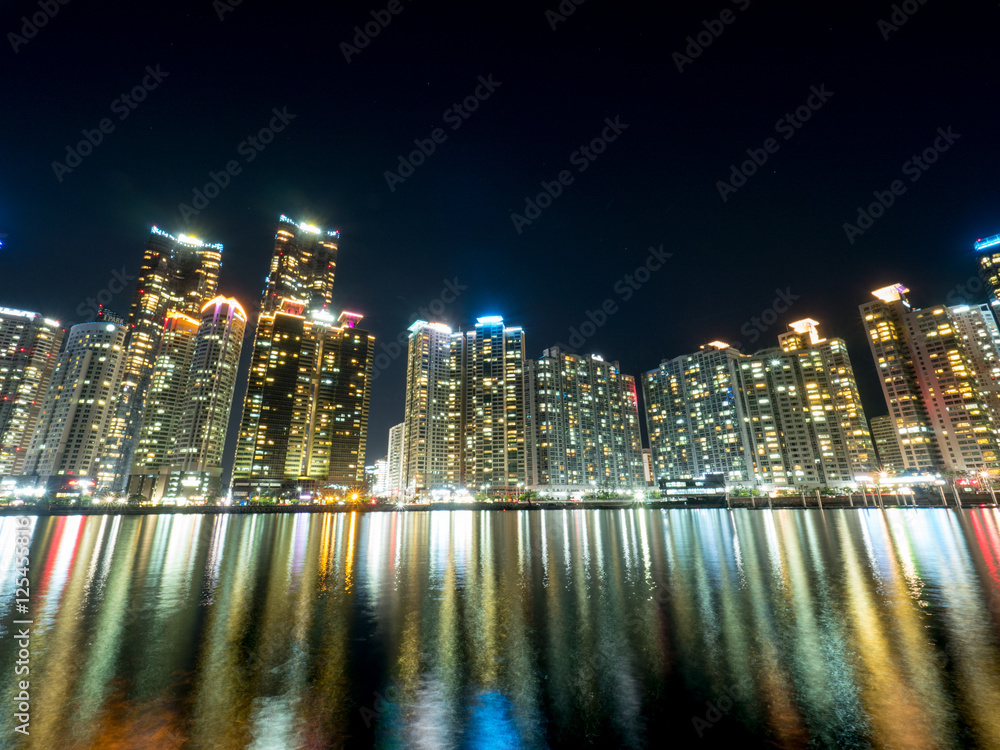 Night view of several buildings over the city's marine harbor in Busan