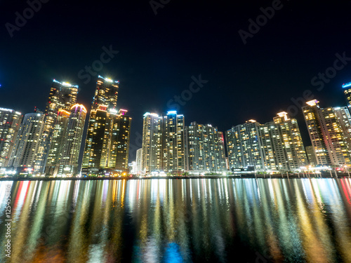 Night view of several buildings over the city s marine harbor in Busan