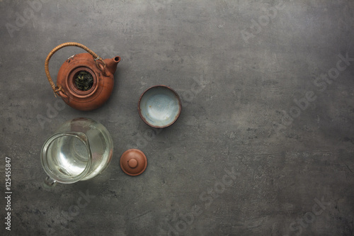 Green tea accessories on kitchen table. 