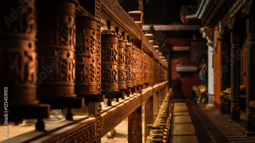 Wooden Prayer Wheels in a temple in Kathmandu, Nepal photo