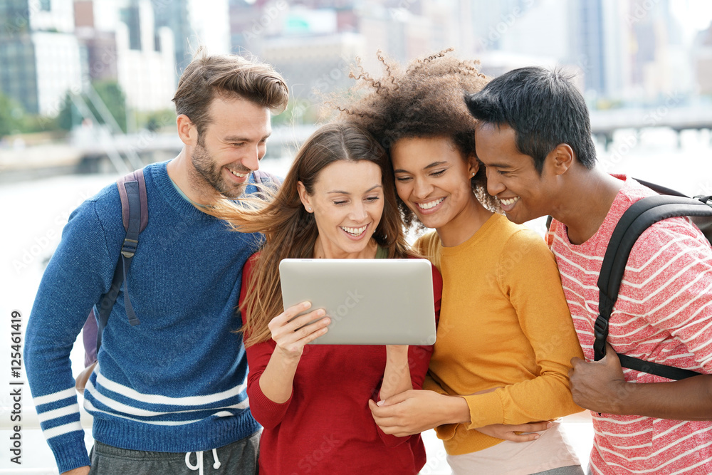 Group of friends in New york city using tablet outside Group of friends in New york city using tablet outside