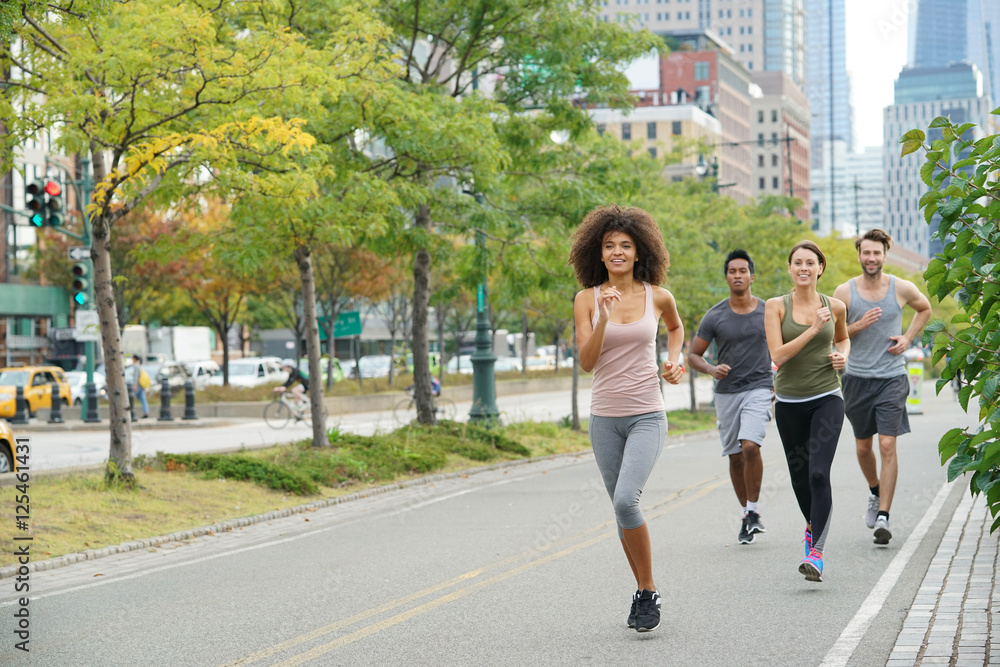 Group of joggers exercising in Manhattan running track Group of joggers exercising in Manhattan running track