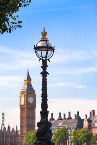 Old Style London View / Vintage street lamp in London with Big Ben clock tower and rooftops of houses