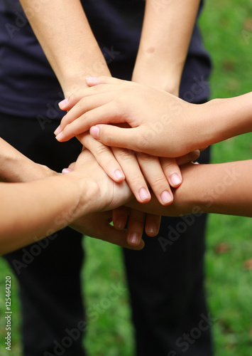Group of people holding hands together