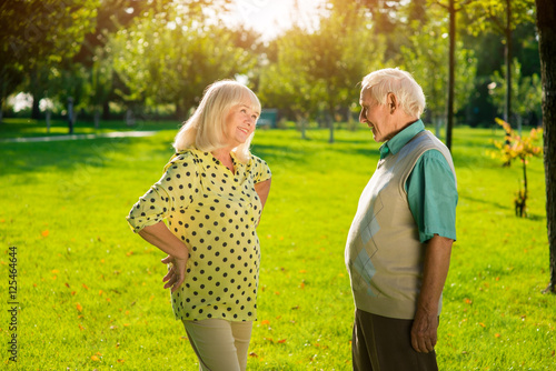 Elderly man and woman outdoor. People on park background. Love and understanding. Life is better with you.