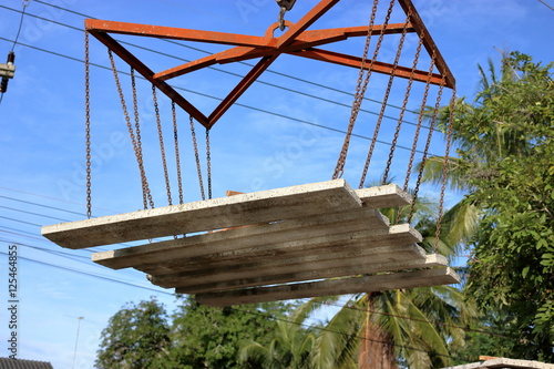 Concrete slabs floating in the sky, Control by mobile crane photo