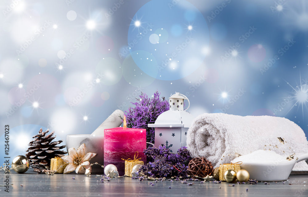 spa massage setting, lavender product, oil and christmas decoration on wooden background, Christmas wellness concept