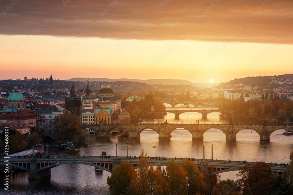 Sunset landscape view to Charles bridge on Vltava river in Prague Czech republic in fall.