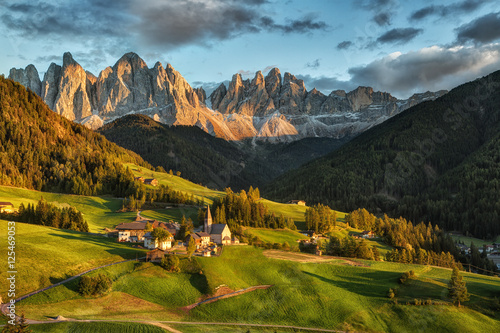 Santa Maddalena village in front of the Geisler or Odle Dolomites Group on sunset, Val di Funes, Italy, Europe. photo