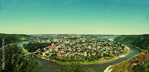 Panorama view of small city round peninsula with river and bridg