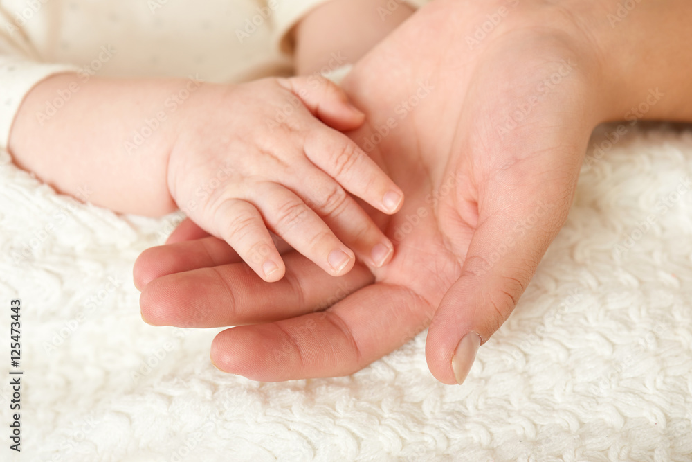 baby and mother hand closeup, happy maternity concept baby and mother hand closeup, happy maternity concept