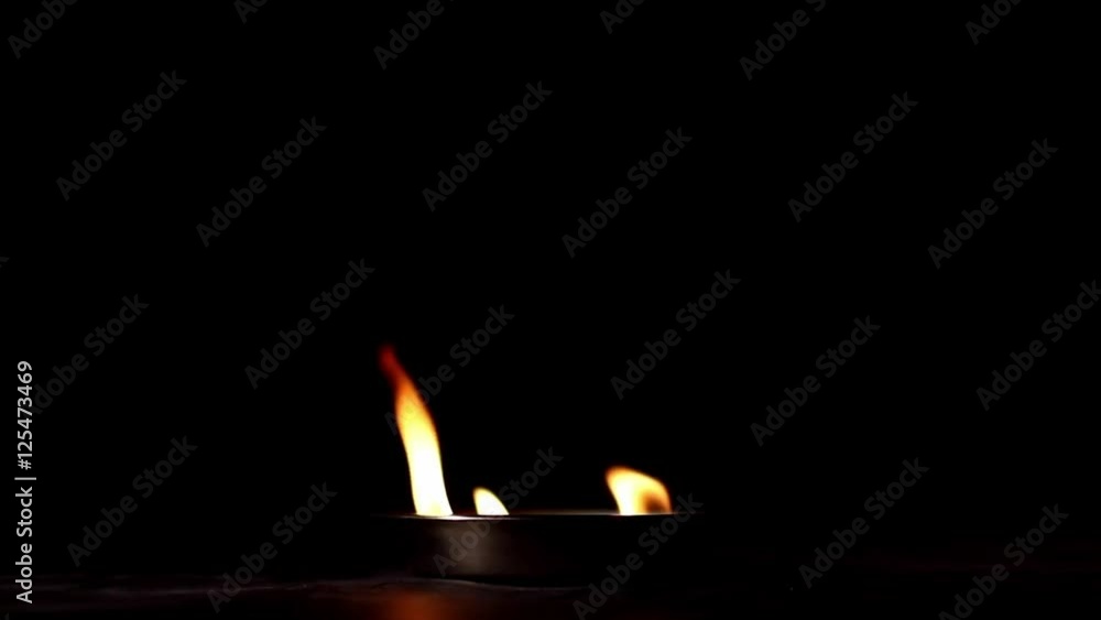 Flame rising in the darkness