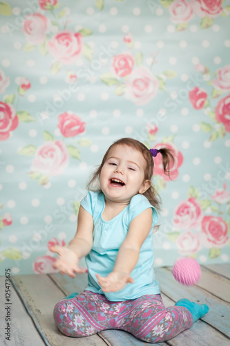 Little girl playing with her knitted toys