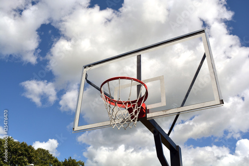 basketball backboard on blue cloudy sky background © Alis Photo