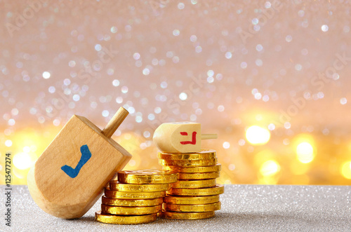 Image of jewish holiday Hanukkah with wooden dreidel photo