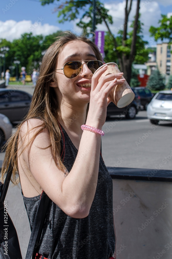 Young woman is drinking coffee 