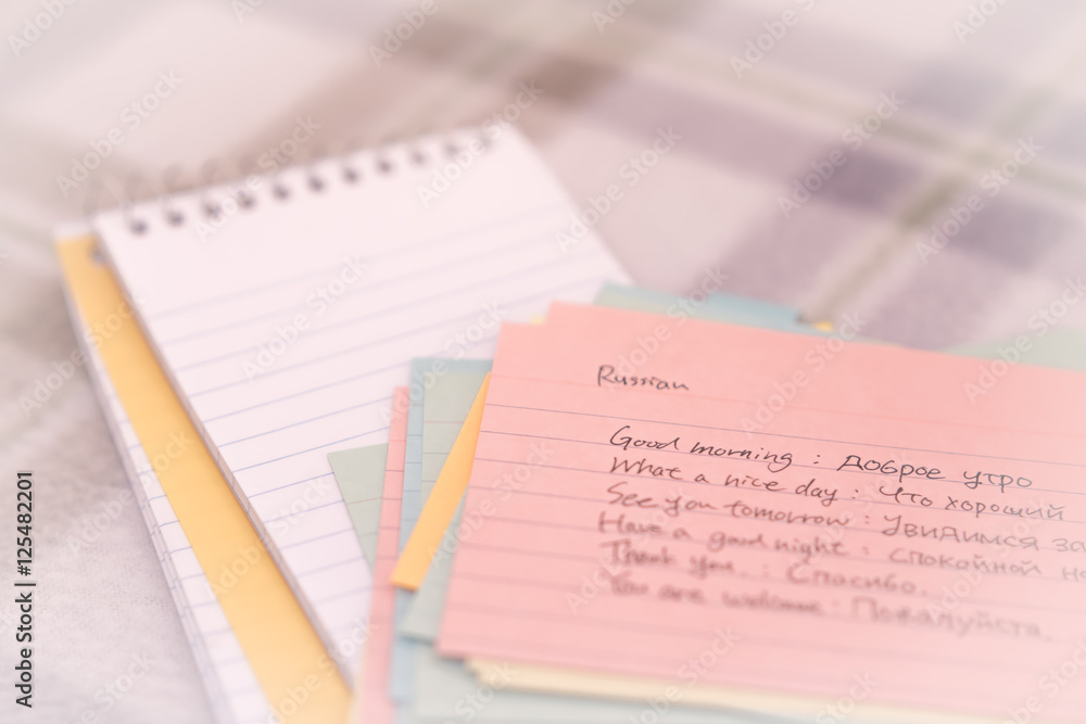 Russian; Learning New Language Writing Greetings on the Notebook Russian; Learning New Language Writing Greetings on the Notebook