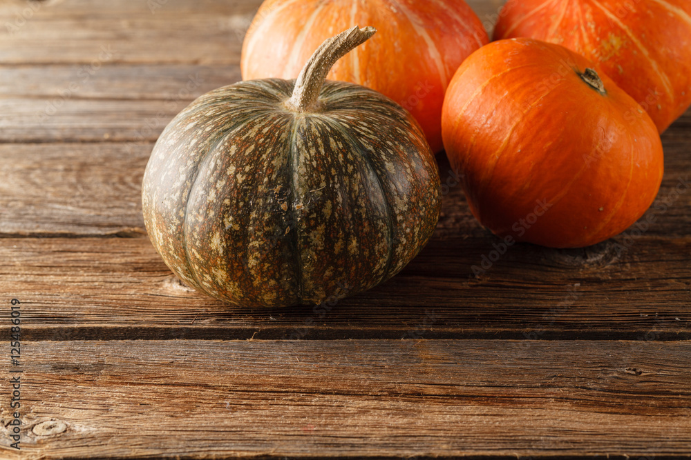 Pumpkin with autumn leaves on wooden table Pumpkin with autumn leaves on wooden table