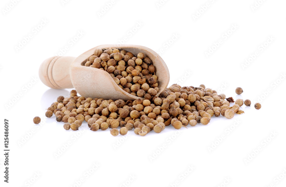 coriander seed in wooden scoop isolated on white background coriander seed in wooden scoop isolated on white background