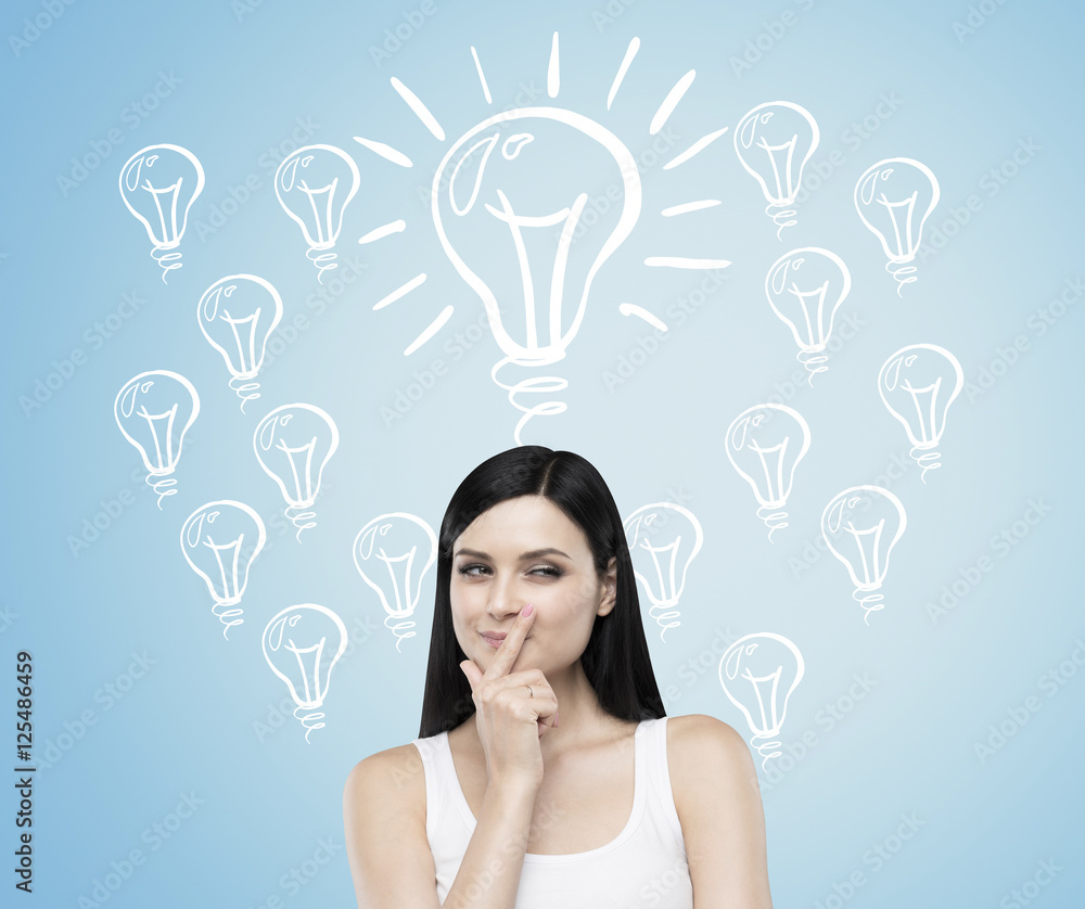 Woman with black hair against blue wall with light bulbs Woman with black hair against blue wall with light bulbs
