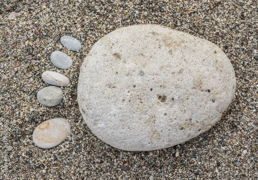 A foot made of pebble on a beach A foot made of pebble on a beach