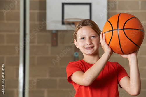 Girl Shooting Basketball In School Gym
