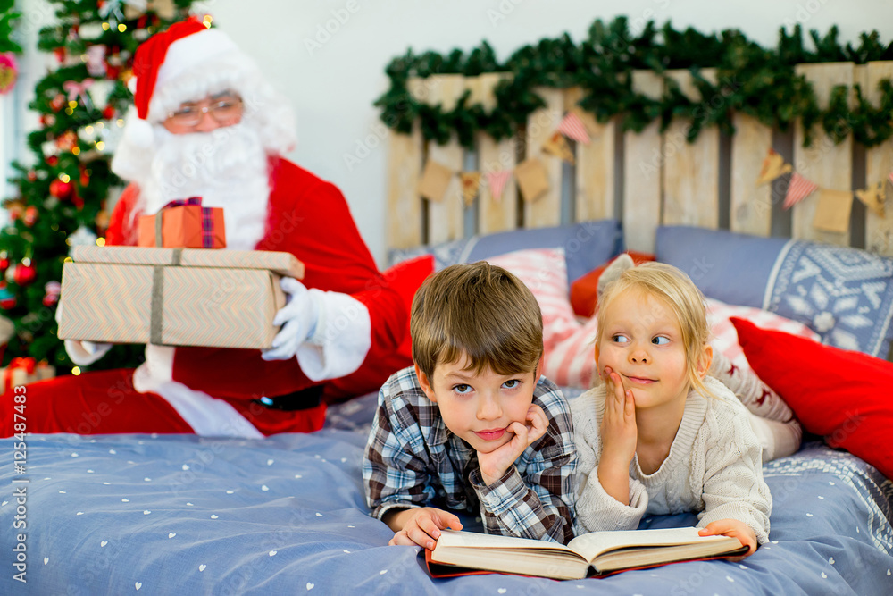 Santa Claus quietly came to the children who are reading Santa Claus quietly came to the children who are reading