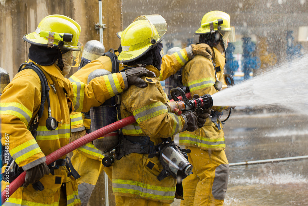 Fototapeta premium Firefighters training, foreground is drop of water springer, Sel