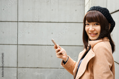 Young attractive woman using her smartphone  photo