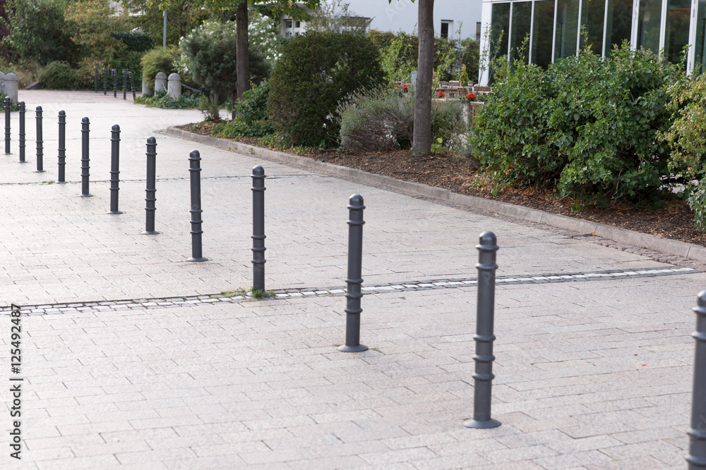Bollards made of metal on a promenade in a row Bollards made of metal on a promenade in a row