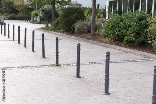Bollards made of metal on a promenade in a row