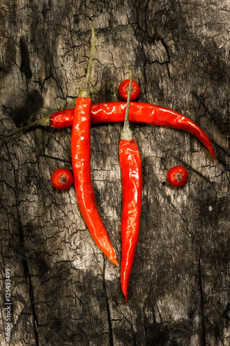 Chile. Red hot pepper chili. On dark wooden background.